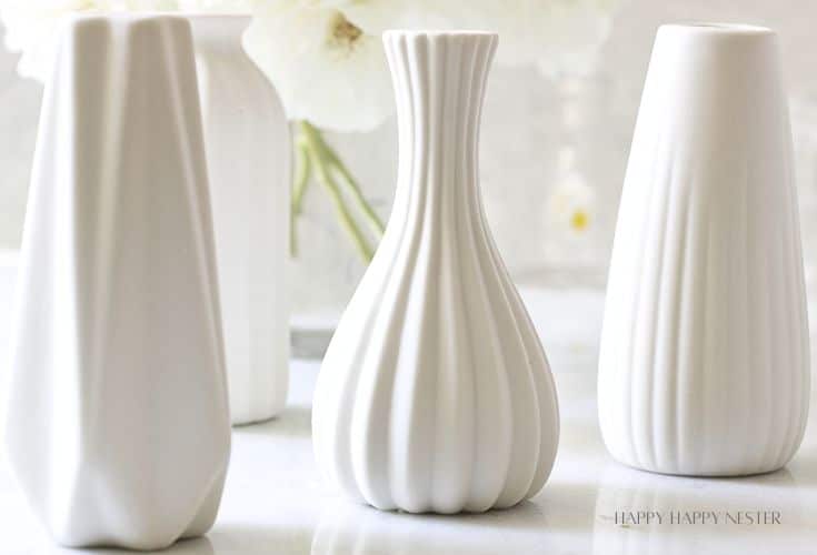 Short white flower vases ready for flower arrangements
