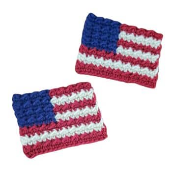 A pair of crocheted American flag patches, each featuring red and white horizontal stripes with a blue rectangle in the upper left corner filled with white dots, representing stars. Both patches have a textured, handmade appearance.