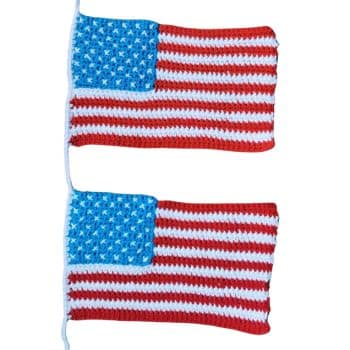 Two rectangular crocheted pieces resembling the American flag, with red and white stripes and a blue field of white stars. One flag is displayed above the other. Both are attached to a white string on the left side.