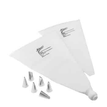 Two white piping bags labeled "Ateco" are shown along with eight metal piping tips of various shapes and sizes, used for decorating cakes and pastries. The tips are arranged neatly near the bags.