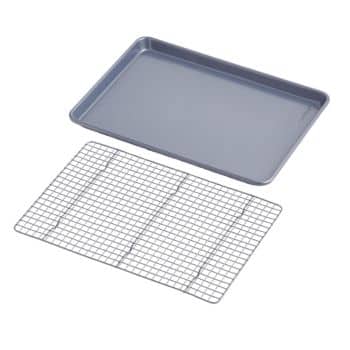 A gray metal baking sheet is placed next to a rectangular cooling rack. The baking sheet has slightly raised edges, and the cooling rack has a grid pattern with metal wires crossing each other to form small squares.