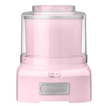 A pink Cuisinart ice cream maker with a cylindrical design and a transparent lid. The machine features a power switch in the center front and the brand name "Cuisinart" displayed on a silver plate at the bottom.