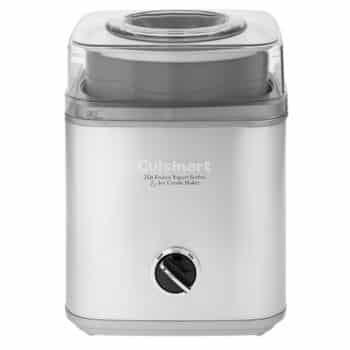 A silver Cuisinart ice cream maker with a clear lid and a control dial on the front. The machine has text that reads "Cuisinart 2 Qt Frozen Yogurt-Sorbet Ice Cream Maker." The appliance has a modern design with a rectangular shape and rounded edges.