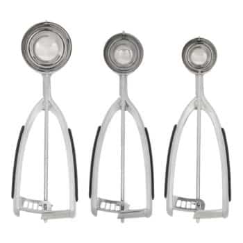 Three stainless steel ice cream scoops of varying sizes are aligned vertically against a plain white background. Each scoop features a rounded bowl and a trigger handle with black grips on both sides for easy use.