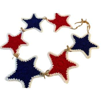 A decorative garland featuring alternating red and blue crocheted star-shaped ornaments with white borders. The stars are connected by short segments of twine. The garland forms a loose circular shape in the image.