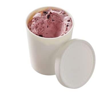 A white, cylindrical container with the lid off, showing a partially used pink-colored ice cream with chunks. The container appears simple and unmarked, and the ice cream has an inviting, creamy texture with pieces of what could be fruit or candy.