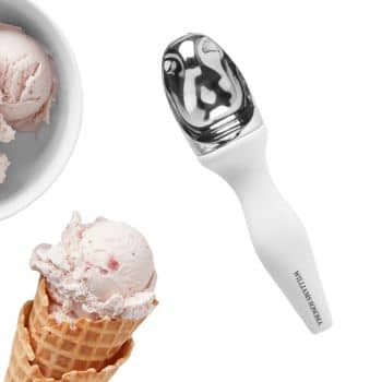 A shiny metal ice cream scoop with a white handle lies on a white surface. To the left are a close-up of a partially filled white bowl of pink ice cream and a pink ice cream scoop served in a waffle cone.