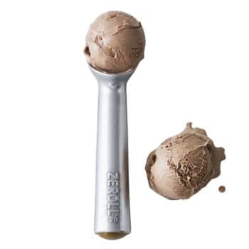 A metal ice cream scoop with one scoop of chocolate ice cream inside and another scoop of chocolate ice cream placed next to it on a white background. The handle of the scoop is labeled "ZEROLL 20.