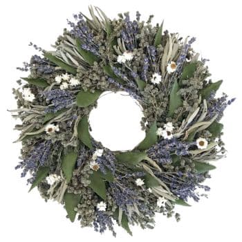 A wreath composed of dried lavender sprigs, small white flowers, and green leaves, arranged in a circular pattern with an open center. The contrast of the purple, white, and green elements provides a natural and rustic appearance.