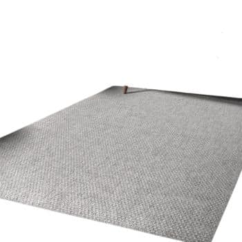 A minimalist image showing a large, grey carpet laid flat. The carpet has a subtle, light textured pattern. Two wooden legs of a piece of furniture are partially visible at the top edge of the image. The background is a blank white space.