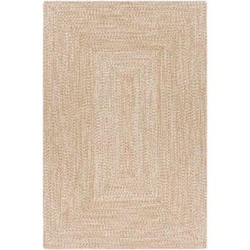 Rectangular beige area rug with a braided pattern forming concentric rectangles. The texture appears soft and woven, adding a touch of warmth and simplicity to the decor.