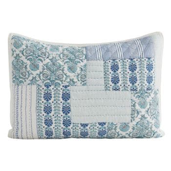 A rectangular decorative pillow featuring a patchwork design in blue and white. The pattern includes various floral, striped, and leafy elements arranged in a quilted style, contributing to a cozy, vintage aesthetic.