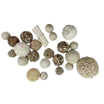 A variety of decorative balls and sticks are arranged on a white background. The items include woven and textured balls in neutral shades of white, beige, and brown, as well as a few small bundles of sticks. The balls vary in size and material.