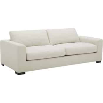 A modern beige sofa with straight, clean lines and block-style arms. It features two seat cushions and two back cushions, all in a matching beige fabric. The sofa stands on four short, dark wooden legs.