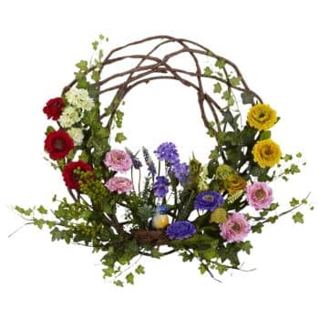 A decorative wreath made of twisted branches, adorned with a variety of colorful flowers including red, yellow, pink, and purple blooms, along with green leaves and small berries. The arrangement has a natural, rustic appearance.