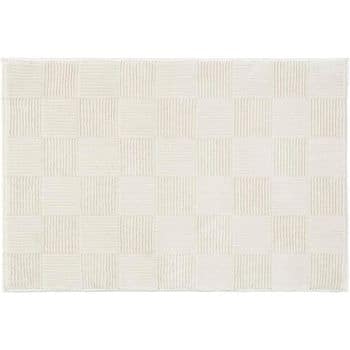 A rectangular white rug featuring a subtle checkerboard pattern. The pattern alternates between solid white squares and white squares with thin vertical lines. The overall design is minimalistic and clean.