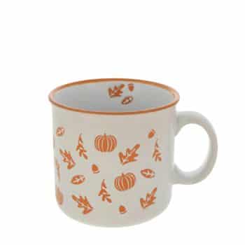 A white ceramic mug with an orange rim. It is adorned with orange seasonal designs, including pumpkins and fall leaves, creating an autumn theme. The mug has a round handle and a plain white interior.