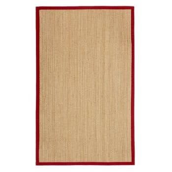 A rectangular beige area rug with a textured surface and a solid red border. The rug has a simple, minimalistic design and appears to be made from natural fibers.