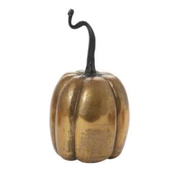 A decorative pumpkin figurine with a golden metallic finish and a dark, twisted stem, resembling a stylized version of a real pumpkin. The surface appears smooth and slightly reflective.