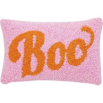 A rectangular pink pillow with a terry cloth texture features the word "Boo" in large, orange, curly letters across the front.