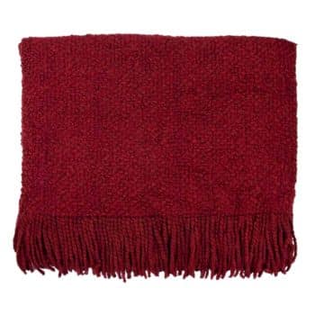 A plush, deep red throw blanket with a textured knit pattern and long fringes along one edge, laid flat. The blanket appears thick and cozy, ideal for adding warmth and a pop of color to a space.