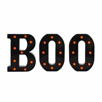 A sign spelling out "BOO" in bold black letters, each letter outlined with small, glowing orange lights—one of the perfect fall decor ideas to add a spooky touch to your home.