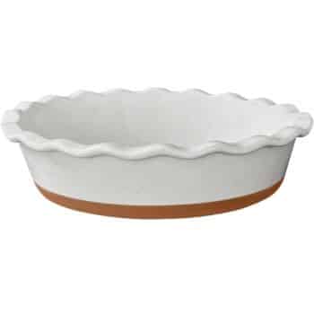 A round, white ceramic pie dish with wavy edges and a brown base. The dish has a speckled pattern and a rustic appearance, perfect for baking and serving autumn recipes.