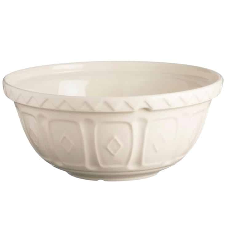 A white ceramic mixing bowl with a subtle diamond pattern and embossed detailing along the rim and body, perfect for preparing your favorite banket recipe. The bowl is empty and set against a plain white background.