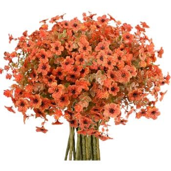 A vibrant bouquet of small orange flowers with delicate petals and green stems. The arrangement is dense, creating a lush and colorful display, ideal for adding a touch of nature and brightness to any setting—perfect for fall decor ideas.