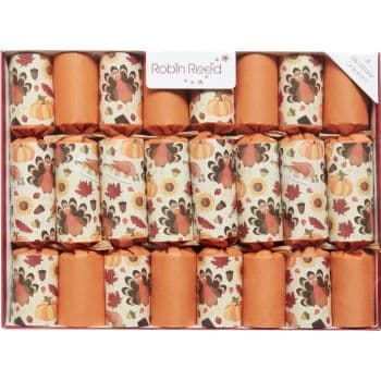 A box of autumn-themed festive crackers featuring orange and patterned designs with pumpkins, leaves, and acorns.