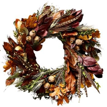 A decorative wreath featuring a mix of brown and red leaves, acorns, pheasant feathers, and small seed pods, creating a rustic, autumnal display.