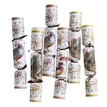 Five festive crackers with bird illustrations and floral patterns, each tied with ribbons on the ends, arranged vertically.