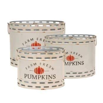 Three white, metal containers with handles are labeled "Farm Fresh Pumpkins" and adorned with an orange pumpkin graphic. The containers vary in size and have a rustic, perforated design.