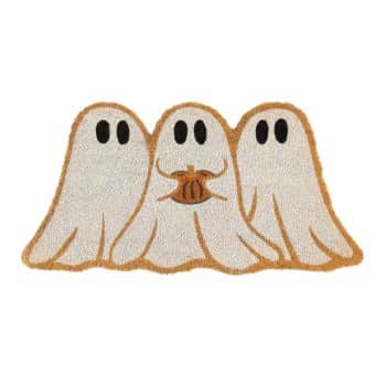 A doormat featuring three cartoon ghost figures with black eyes draped in white sheets. The middle ghost is holding a small orange pumpkin. The edges of the doormat have an orange border.