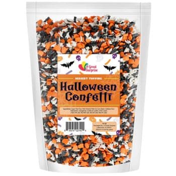 A package of Halloween Confetti dessert topping offers an assortment of orange, black, and white sprinkles. Perfect for halloween treats for kids, the label showcases bats, pumpkins, and reads "Great Surprise, Halloween Confetti.