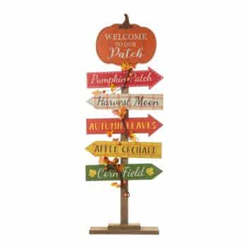 A decorative fall signpost with a pumpkin top reading "Welcome to our Patch," perfect as front door decor for fall. Arrow signs below point to Pumpkin Patch, Harvest Moon, Apple Orchard, and Corn Field, all adorned with autumn leaves.