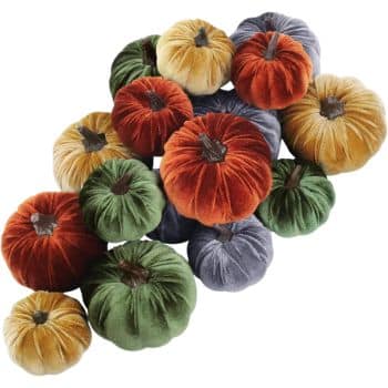 A collection of plush pumpkins in various vibrant colors, perfect for easy pumpkin crafts, including orange, green, yellow, and gray. Each pumpkin boasts a soft, velvety texture and a charming brown stem.