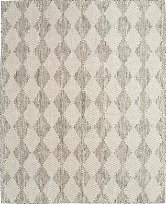 A geometric patterned rug featuring a diamond design in shades of gray and off-white adds charm to your fall decorating ideas. The rug's textured appearance creates a subtle contrast between the colors, perfect for cozy autumn vibes.