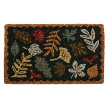 A rectangular doormat decorated with various colorful autumn leaves. The background is dark, highlighting leaves in shades of red, orange, yellow, green, and brown. The edge of the doormat is a lighter brown, creating a border around the leaf patterns.