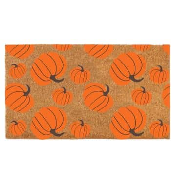 A doormat with a brown coir background is patterned with various sizes of bright orange pumpkins, each featuring a dark brown stem. The design is festive and suitable for autumn or Halloween decor.