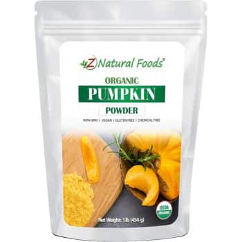 Packaging of Z Natural Foods Organic Pumpkin Powder highlights its appeal for creating Halloween treats for kids. The front features a photo of fresh pumpkin slices with the powder. Labels confirm it's non-GMO, vegan, gluten-free, and chemical-free, with a net weight of 1 lb (454 g).