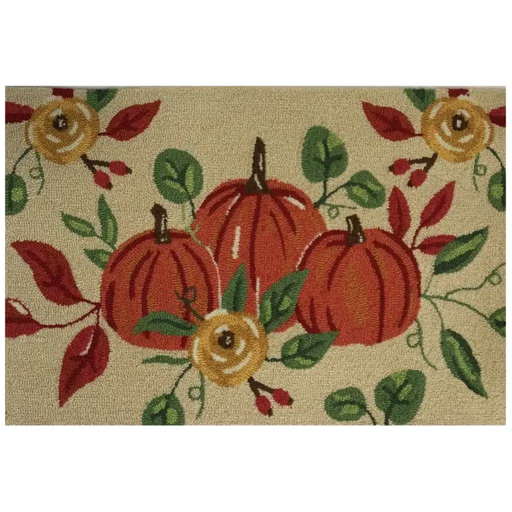 A decorative mat featuring three orange pumpkins surrounded by green leaves, red berries, and yellow flowers on a beige background—perfect front door decor for fall.