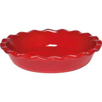 Red ceramic pie dish with a scalloped edge, perfect for baking fall pies, viewed from above.