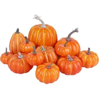 A group of small to medium-sized orange pumpkins with stems is artfully arranged in a pile, perfect for inspiring easy pumpkin crafts. These pumpkins, with varying shapes and textures, showcase rich orange hues and light vertical stripes.