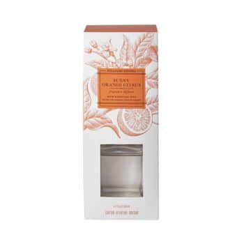 A white rectangular box with an orange label and citrus illustrations. The label reads "Sunny Orange Citrus" fine fragrance diffuser by William Sonoma. A transparent window displays the contents inside.