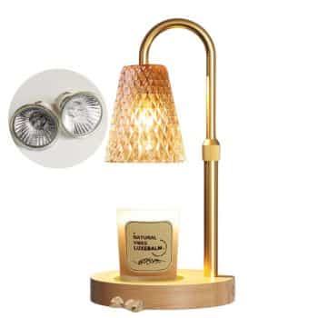 A decorative lamp with a golden metal frame and a diamond-patterned glass shade. Below, there's a lit candle on a wooden base. An inset image shows two replacement halogen bulbs.