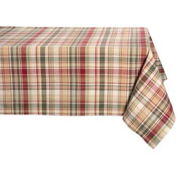 A table is covered with a plaid tablecloth featuring a pattern of red, green, and beige stripes. The cloth drapes over the edges of the table.