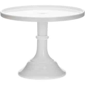 A white, round cake stand with a smooth, flat top and a single pedestal base. The design is simple and elegant, suitable for displaying cakes or desserts.