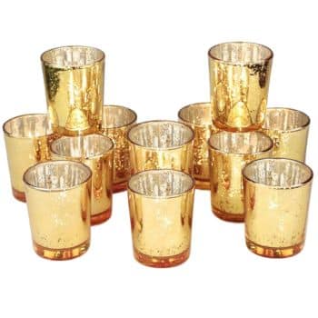 A collection of ten gold speckled glass votive candle holders arranged in a triangular formation. The holders have a reflective inner surface, creating a warm and elegant look.