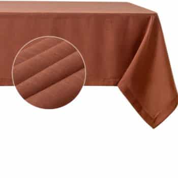 A brown tablecloth draped over a rectangular table, showcasing a magnified view of its textured fabric pattern.